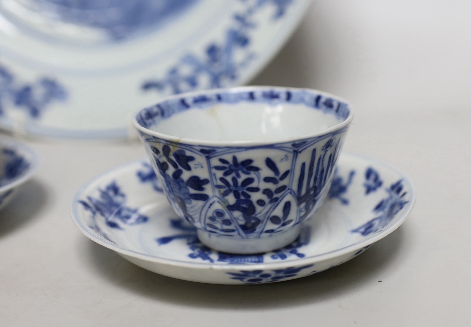 A Chinese blue and white landscape dish, Qianlong period 31cm diameter, together with a similar pair of tea bowls and saucers